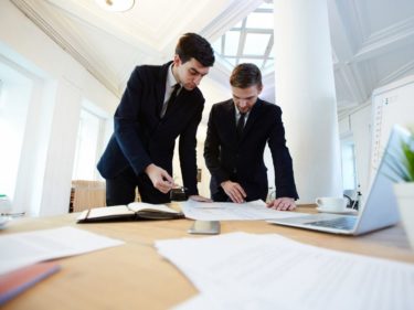 two men looking at plans